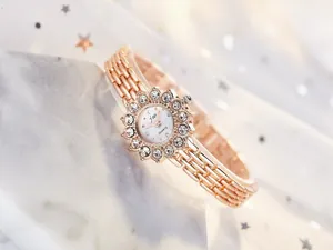 Macro view of luxury rose gold watch featuring a rhinestone bezel and mesh chain strap