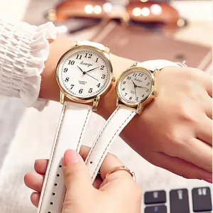Elegant gold quartz couple watches with white leather straps and classic round dials