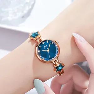 Women's rose gold chain watch with navy dial and blue star-shaped crystal charms