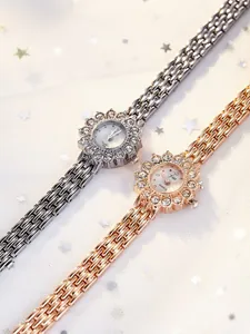 Detail of luxury women's watches featuring rhinestone flower dials in silver and rose gold