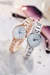 Close-up of elegant rose gold and silver quartz watches with chic metal chain straps