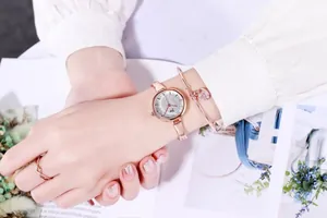 Detail of rose gold jewelry set featuring crystal watch, heart bracelet, and infinity ring