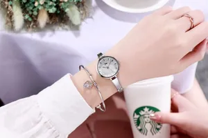 Silver ladies watch set with crystal dial and heart pendant bracelet on wrist