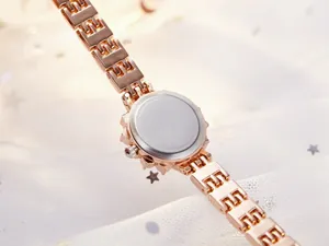 Detail of rose gold metal strap and stainless steel case back of a luxury women watch