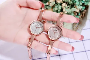 Detail of rose gold jewelry watches with shimmering dials and delicate chain bracelets