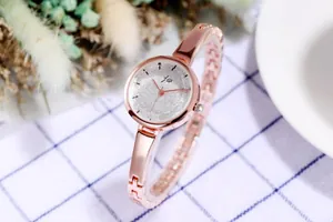 Detailed close-up of rose gold bracelet watch with sparkling silver glitter dial for women