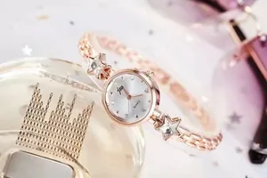 Detail of rose gold fashion watch with star bracelet and crystal pearl dial