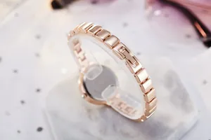 Detailed close-up of the elegant rose gold chain strap and stainless steel watch case