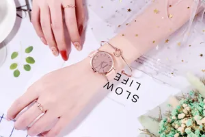 Pink starry dial watch set with rose gold case, matching bracelet, and stylish rings