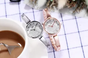 Detailed view of silver and rose gold metal bangle watches with starlight dials