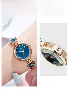 Detailed close-up of blue sunray dial with star-link rose gold metal watch band
