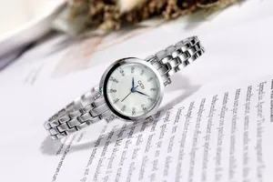 Detail of GEDI women's watch featuring a white dial, blue hands and crystal markers