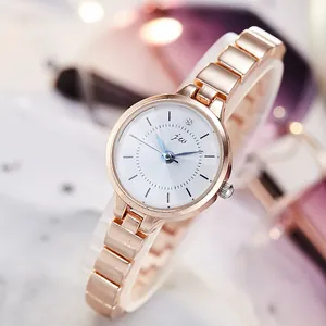 Elegant rose gold women's watch with blue hands and white dial on a sleek metal chain strap