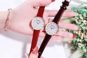 Detail of elegant red leather strap watches with rose gold cases and starry dial finish