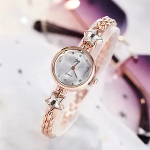 Fashion rose gold women's quartz watch with star-shaped link chain bracelet on stand