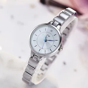 Elegant women's analog watch with silver metal band and diamond accent on marble background