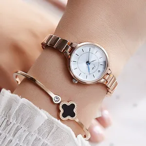 Women's rose gold watch and black clover bracelet set shown on a wrist