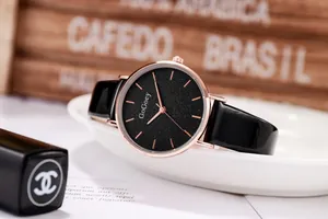 Detail of elegant women's watch featuring a black starry dial and rose gold metal casing