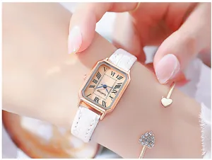 Close-up of a ladies' quartz watch with rose gold rectangular case and white leather strap
