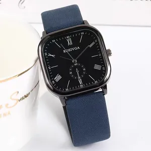 Detail of square black dial watch with blue matte strap and Roman numerals on desk