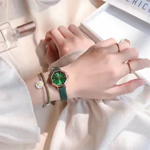 Close-up of stylish octagon quartz watch with green leather strap and matching jewelry