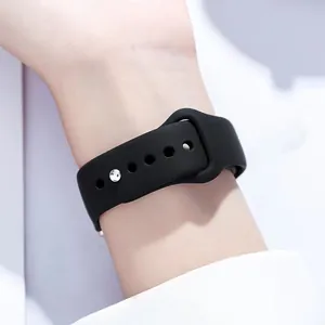 Close-up of black matte silicone watch strap with adjustable pin-and-tuck closure