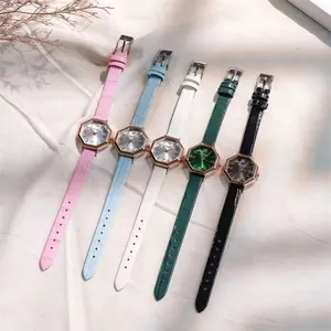Flat lay of octagon quartz watches with colorful leather straps and rose gold cases