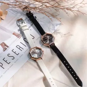 Octagonal rose gold quartz watch with leather strap and roman numerals on marble surface