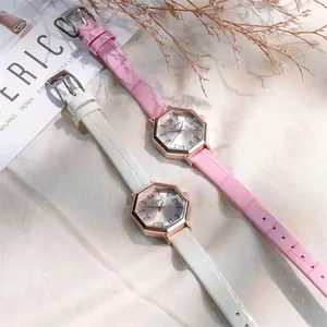 Macro shot of octagon quartz watch dials with Roman numerals and leather texture straps