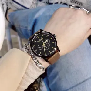 Detail of luxury watch with black dial, calendar window and brown leather strap