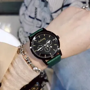 Macro detail of GoGoey watch with multi-function dials and dark green leather strap