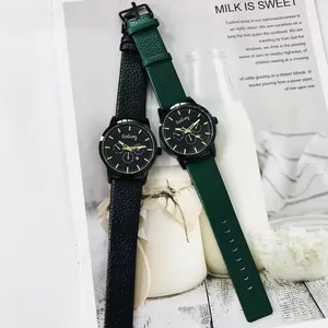 Detail of GoGoey quartz watches with black and green leather straps and gold markers