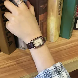 Elegant rectangular women's quartz watch with gold case and brown leather crocodile strap