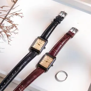 Macro view of vintage rectangular quartz watches with leather straps and Roman numerals