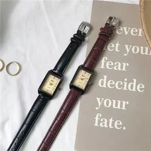 Close-up of vintage rectangular quartz watches with crocodile texture leather straps
