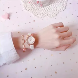 Detail of cute cat ear watch with white leather strap and matching moon charm bracelet