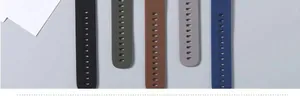 Detailed macro view of five silicone watch straps in black, green, brown, grey and blue