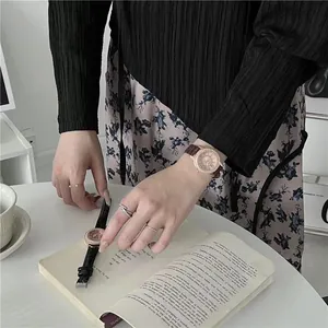 Elegant starry dial women's quartz watch with leather strap in a lifestyle setting