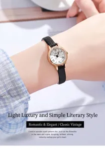Gros plan d'une montre à quartz vintage avec boîtier or rose et bracelet en cuir noir