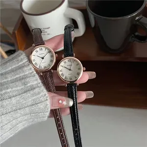 Detail view of vintage Roman numeral dials and textured leather straps in black and brown
