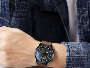 Macro detail of men's watch with black dial, Arabic numerals, and brown silicone strap