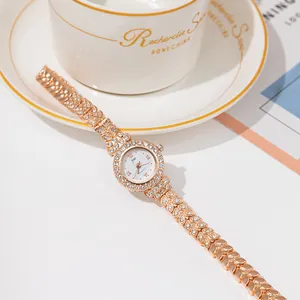 Elegant rose gold quartz watch with crystal bezel and leaf-shaped metal link bracelet