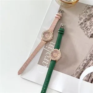 Close-up of pink and green leather strap watches with crystal-set rose gold cases