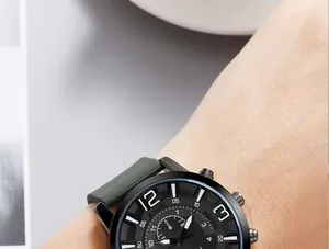 Close-up of black dial watch with green silicone strap and multifunctional subdials
