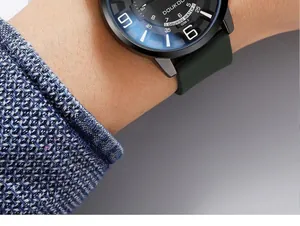 Close-up of a Doukou quartz watch with dark green silicone strap on a male wrist