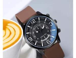 Close-up of a large black dial watch with white numerals and a brown leather strap