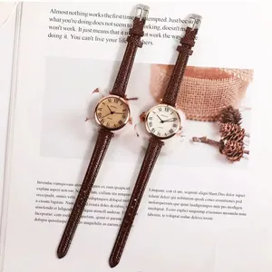 Retro quartz watches with roman numerals and brown lizard pattern leather straps on magazine