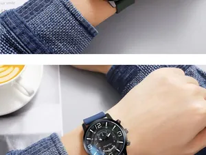 Detail of a large dial watch with blue silicone strap and chronograph features