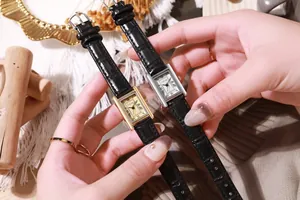Detail of vintage rectangular quartz watches with black leather straps and Roman numerals