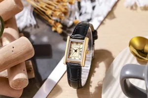Close-up of vintage rectangular quartz watch with black leather strap and gold-tone case